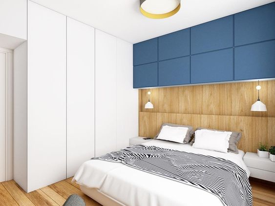 В современной спальной комнате шкаф не является самостоятельным элементом, а делается комплексная меблировка, которая включает застройку пространства над кроватной спинкой